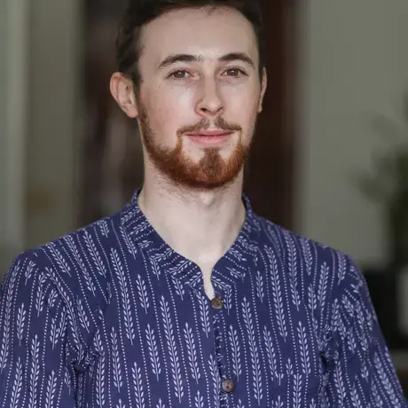 A close-up shot of Jack in a printed blue shirt.