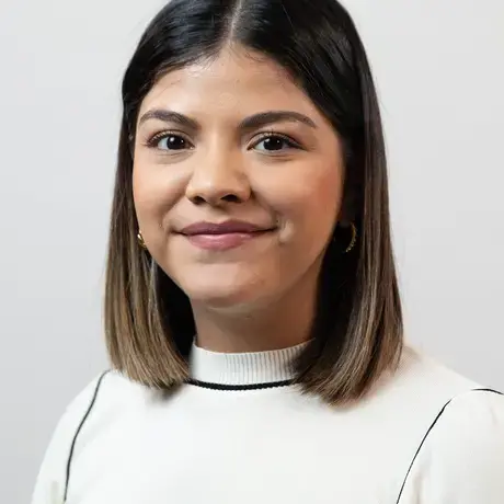 Headshot of Alejandra Martinez wearing a white top