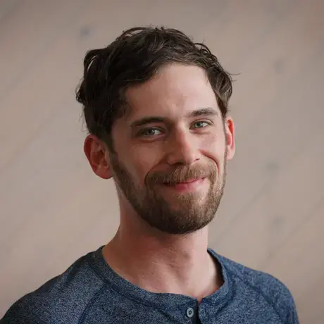 Headshot of Matthew wearing a blue shirt