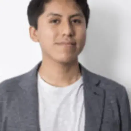 Headshot of Gianfranco wearing a grey blazer and white tshirt