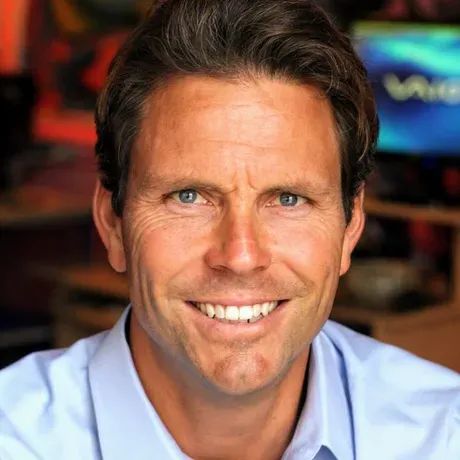 Casey is a white man with short light brown hair smiling into the camera.