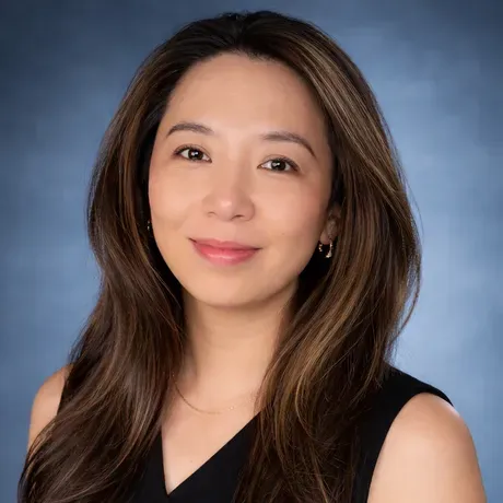 Ming Jin is an asian woman with long brown smiling into the camera.