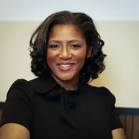 Carletta Hurt wearing a black shirt and smiling into the camera