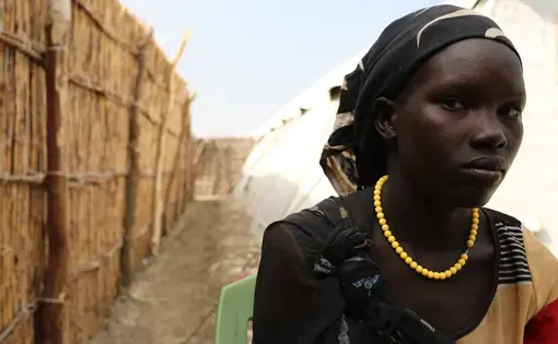 Elizabeth poses for a photo on Dec. 15, 2015 at the U.N. base in Bentiu, South Sudan. She fled recent fighting in Leer County. Image by Cassandra Vinograd. South Sudan, 2016.