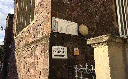Client's entrance to St. Petrock's, a homeless charity based in Exeter. Image by Caitlin Bawn. England, 2016.