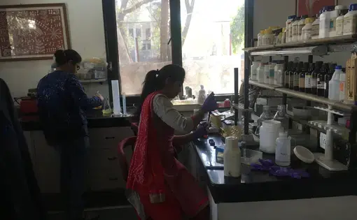 Two lab assistants prepare for clinical trials of a contraceptive vaccine at the Talwar Foundation in Delhi. Image by Hannah Harris Green. India, 2018.