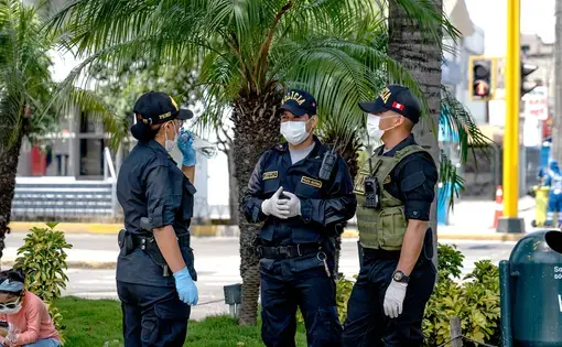 Police wearing masks and gloves amid coronavirus outbreak in South America. Image by Myriam B / Shutterstock. Peru, 2020.