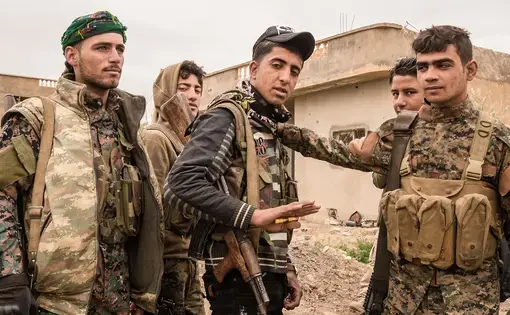 Fighters from Raqqa belonging to the SDF Syrian Democratic Forces getting ready for the fight against ISIS. Image by Olmo Couto / Shutterstock. Syria, 2019.