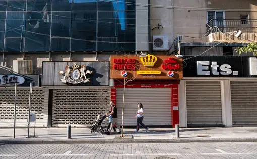 A family walks in Hamra, Beirut. Stores and restaurants are closed due to the Covid-19 virus. Image by Hassan Chamoun / Shutterstock.com. Lebanon, 2020.