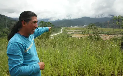 Luis Sánchez Shiminaycela points to the construction works near the house he was evicted from. Image by Andrés Bermúdez Liévano. Ecuador, 2019.