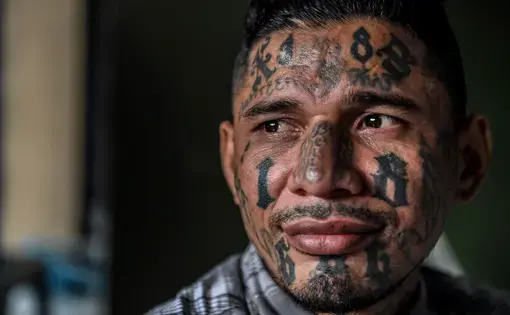 A born-again member of the 18th Street gang now living in the Eben Ezer evangelical church. Image by Neil Brandvold. El Salvador, 2018.