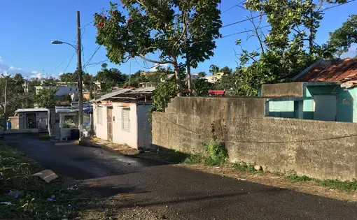 A row of houses in Guayama, destroyed and unfixed six months after Hurricane Maria. Image by Isabel S. Dieppa. Puerto Rico, 2017.