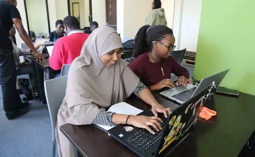 Two students at the Moringa School based in Nairobi work on developing their coding skills. Image by Janelle Richards. Kenya, 2017.