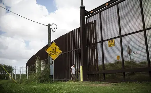 Juan Cavazos of Brownsville, Texas at the electronic gate in the border fence that runs through his property. Image by Martin do Nascimento for The Texas Tribune. United States, 2017.