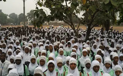 Students sing the national anthem before class at a secondary school in Koidu, district of Kono, Sierra Leone, Friday, Nov. 20, 2020. Image by Leo Correa/AP Photo. Sierra Leone, 2020.