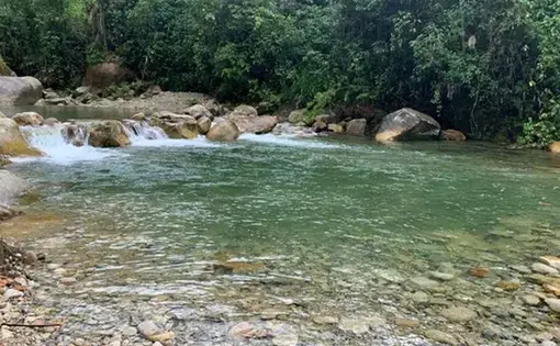 Clear blue river tucked away in the mountains.