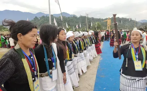 People stand in a line during a ceremony