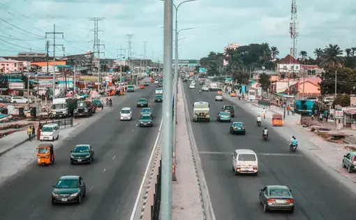 Cars pass by a road.