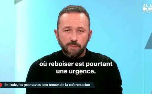 A person wears a black turtleneck.