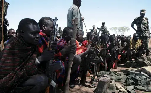 Young men carrying weapons