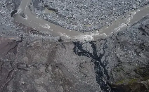 A piece of land and mud in dark colors