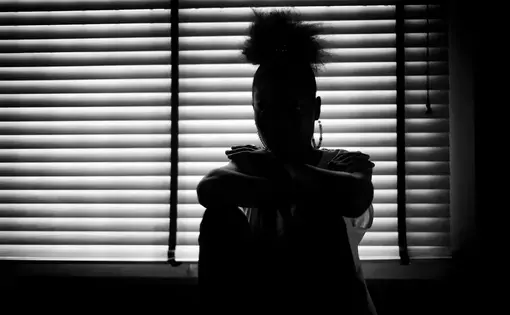 woman's shadow in window