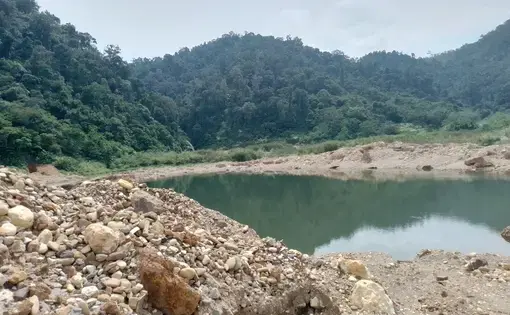 A ground view of a former gold mine and deforested area.