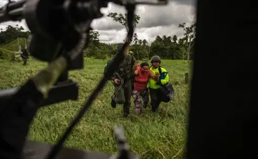 A woman is dragged by military forces