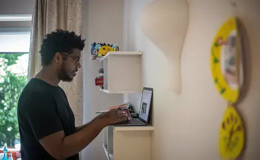 A man works on his laptop