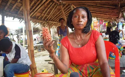 a woman hold seeds in her hand