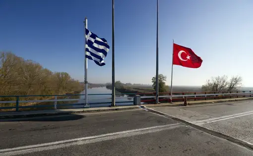 The Greek-Turkish border line right on the bridge over the river Evros, in Thrace region. The grey line on the road marks the exact point where the two countries meet or separate.