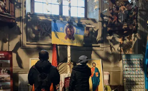 Two parishioners pray
