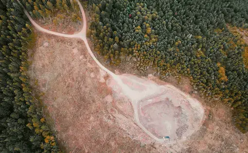 An aerial shot of forest clearings.