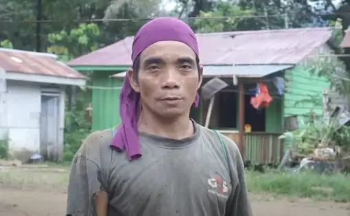 A person from the rainforest looks into the camera