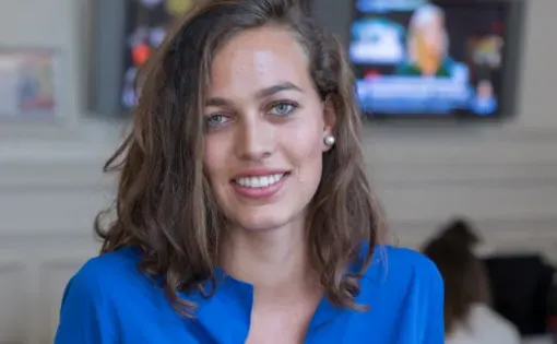 Paloma dons a bright blue shirt.