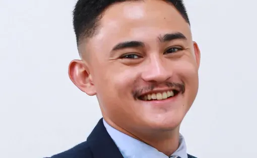 Headshot of man in blue suit
