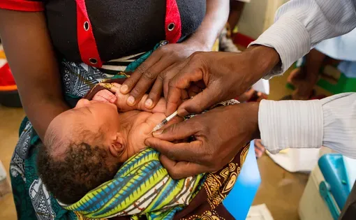people holding a newborn baby, October 2012. Kasungu District Malawi. Image by Ben Houdijk/Shutterstock.