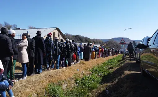 Ex-miners and claimants for silicosis and work-related tuberculosis compensation queue at The Employment Bureau of Africa (TEBA) in Maseru during Tshiamiso Trust outreach