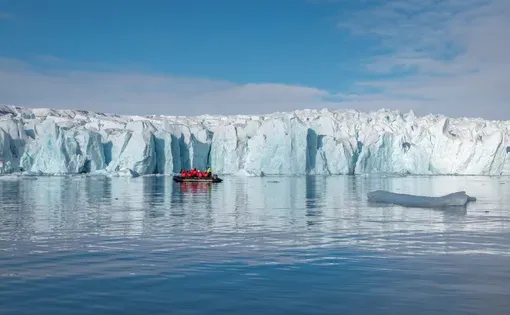 Expedition cruise boat sail along the glacier at Crocker Bay on Devon Island, north Canadian Arctic, Nunavut