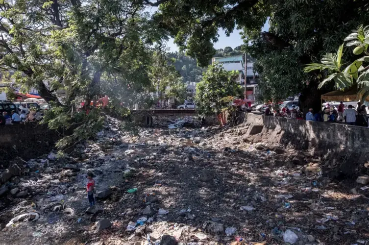 Trash littered a dry riverbed in Mutsamudu on Anjouan’s north shore. Image by Tommy Trenchard for The New York Times. Comoros, 2019.