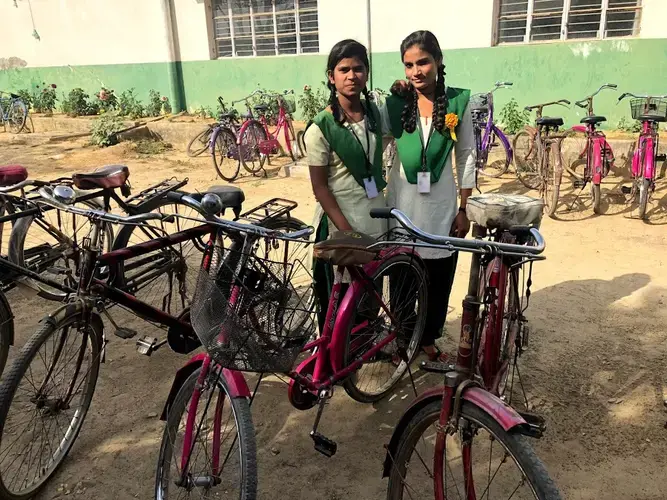 Sonam, with a friend, stands by her bicycle outside Pardada Pardadi's school. Image&nbsp;by Annalisa Merelli. India, 2018.