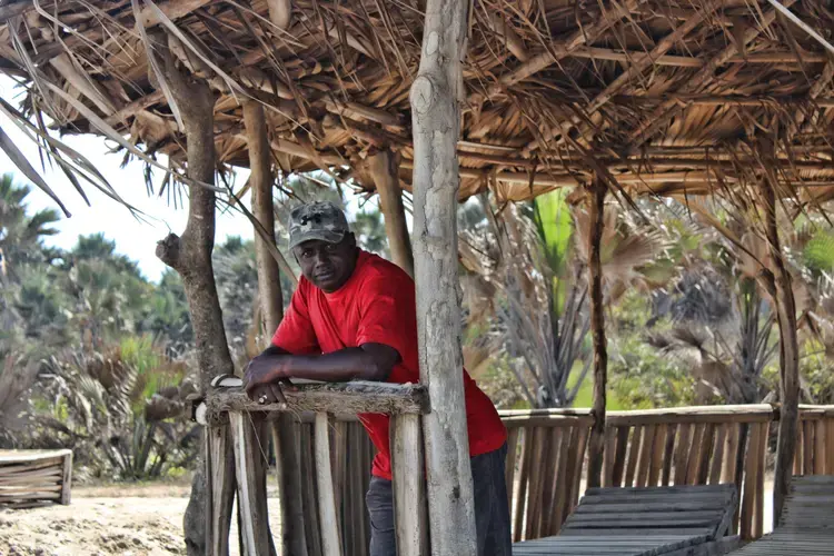 Lamin Jammeh looks out onto the North Atlantic Ocean. The environmental activist is head of Environmental Concern Group Gunjur which, along with other local groups, has brought a civil lawsuit against Golden Lead fishmeal factory on behalf of residents. Image by Nosmot&nbsp;Gbadamosi. The Gambia, 2018.