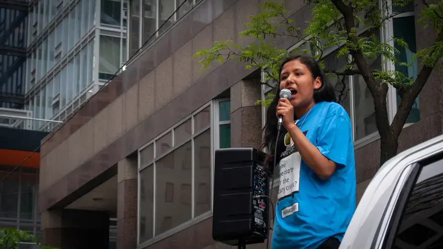 Paris Meekis, a Grassy Narrows teen, stands before the gathered crowd and speaks passionately about her community.&nbsp;Canada, 2019. Image by Shelby Gilson.