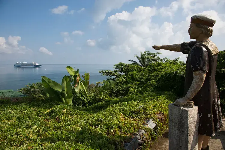 A statue of Christopher Columbus on a lookout in Trujillo points to the spot where the explorer first landed on mainland Central America.&nbsp;Image by Susan Meiselas/Magnum Photos. Honduras, 2018.