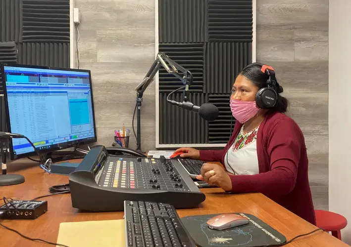 Lidia López prepares to go on-air from Radio Indígena's programming booth in Oxnard in July. Image by&nbsp;Julia Knoerr. United States, 2020.