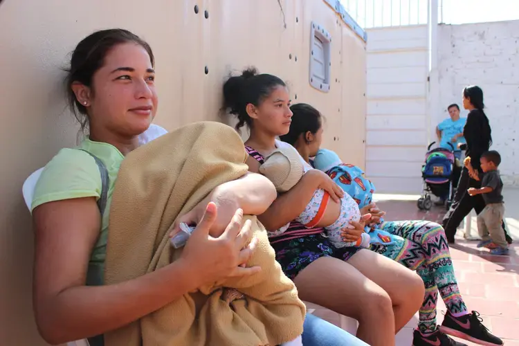 Venezuelan mothers wait to vaccinate their babies at a humanitarian clinic in La Parada, Cucuta, Colombia. Many new mothers regularly make the journey to Colombia to seek medical treatment.&nbsp;Image by Mariana Rivas. Colombia, 2019.