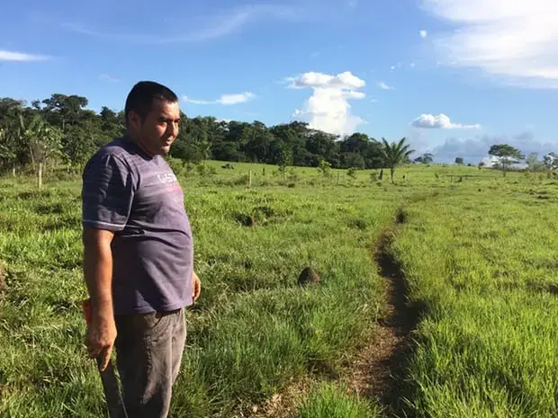  Vergara in his pasture. The termite mounds are evidence of poor soil quality to grow the grasses for cattle. Image by Lisa Palmer. Colombia, 2017.