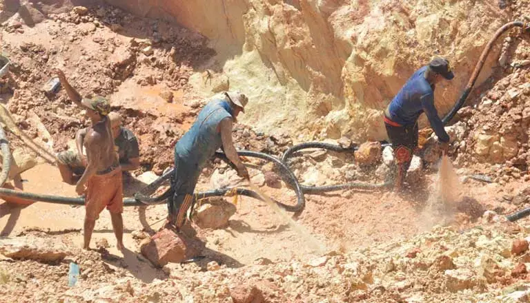 Gold miners work an illegal claim. Mining is highly destructive of the environment, denuding the landscape and poisoning waterways. Image by Wilmer González. Venezuela, 2017.