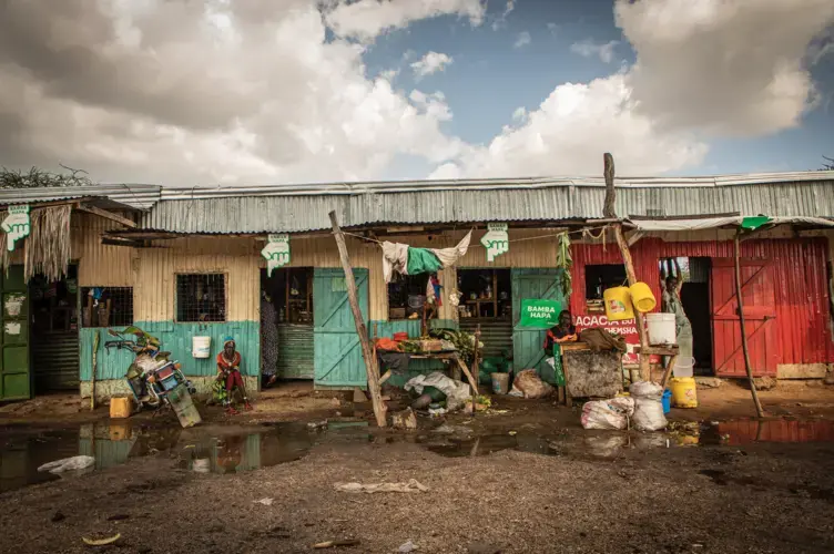 Traders and locals sit outside their stores in the Rendille town of Merille in Kenya.&nbsp;Image by Will Swanson. Kenya, 2020.