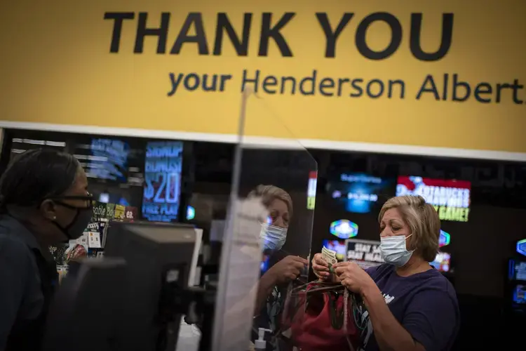 Norma Flores, 54, pays for her groceries at a store near her home in Henderson, Nev., Tuesday, Nov. 10, 2020.&nbsp;Image by Wong Maye-E / AP Photo. United States, 2020.